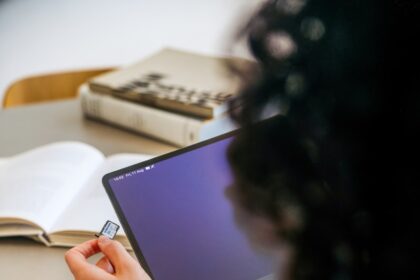 A woman sitting at a table with a laptop computer