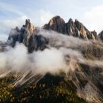 A mountain range covered in clouds and trees